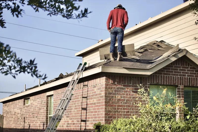 Professional roofer working on a residential roof in Gulf Gate Estates